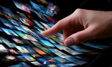 Person navigating digital media and information on a touchscreen interface.